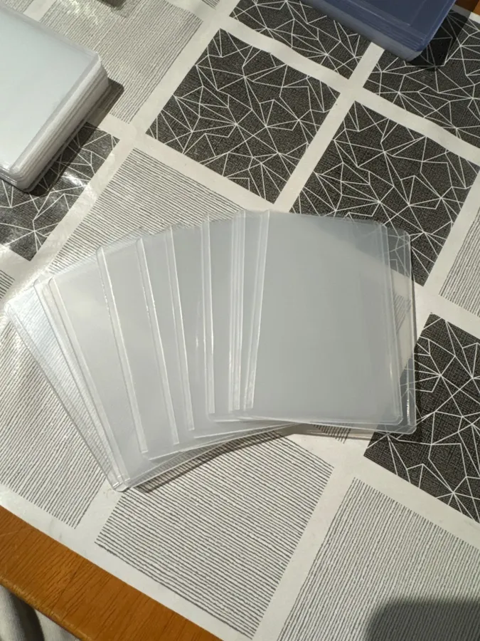 Buyer photo of clear sleeves fanned out on a table